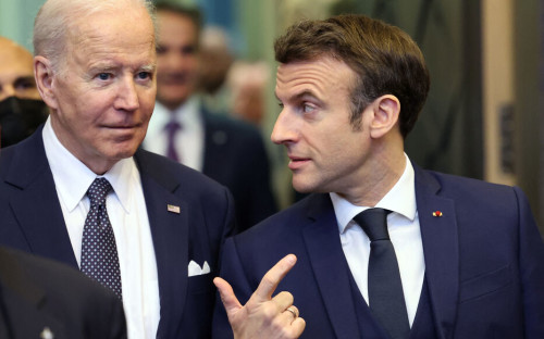 U.S. President Joe Biden (L) and French President Emmanuel Macron arrive to attend a North Atlantic Council meeting during a NATO summit at NATO Headquarters in Brussels on March 24, 2022. (Photo by Thomas COEX / AFP)