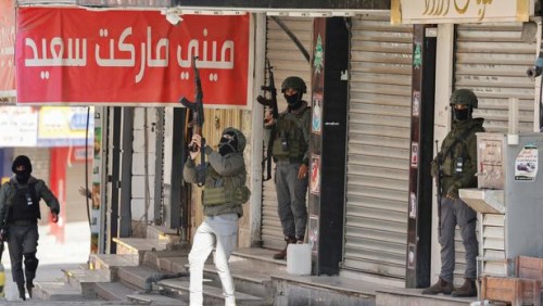 Palestinian security forces take position during clashes with militants at the camp, in Jenin in the Israeli-occupied West Bank, December 14, 2024. REUTERS/Raneen Sawafta     TPX IMAGES OF THE DAY