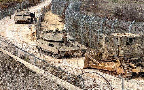 Israeli tanks and a military vehicle are seen on the Golan Heights side of the ceasefire line between Syria and the Israeli-occupied Golan Heights, December 11, 2024. REUTERS/Avi Ohayon