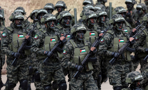 FILE PHOTO: Palestinian Hamas militants take part in a rally marking the 31st anniversary of Hamas' founding, in Gaza City December 16, 2018. REUTERS/Ibraheem Abu Mustafa/File Photo